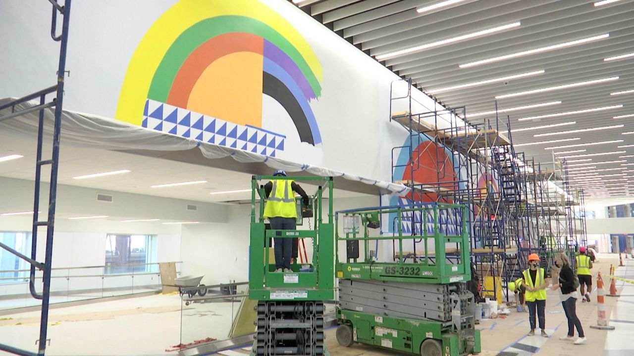 Artists put in months of work to create larger-than-life murals for new CVG facility